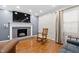 Comfortable living room with a cozy fireplace, hardwood floors, and ample natural light at 1201 Deerfield Dr, Cary, NC 27511