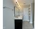 A bathroom featuring a double sink vanity, stylish lighting, and modern tile flooring at 128 Barclay Rd, Durham, NC 27712