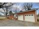 Charming single-story brick home with a two-car garage and a welcoming front entrance at 128 Barclay Rd, Durham, NC 27712