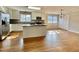 Bright kitchen features white cabinets, stainless steel appliances, granite countertops, and hardwood floors at 128 Barclay Rd, Durham, NC 27712