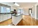 Updated kitchen with white cabinets, stainless appliances, granite countertops, and hardwood floors at 128 Barclay Rd, Durham, NC 27712