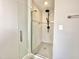 Modern walk-in shower showcasing tiled walls, glass doors, and sleek fixtures at 128 Barclay Rd, Durham, NC 27712