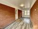 Enclosed brick sunroom with vinyl flooring and view of front yard at 128 Barclay Rd, Durham, NC 27712