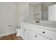 White bathroom features a toilet, vanity with hardware, and large mirror with faucet at 1286 W Blackman Rd, Dunn, NC 28334