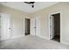 Bedroom with carpet, white trim, three doors, and view into the hall and closet at 1286 W Blackman Rd, Dunn, NC 28334