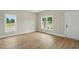 Bright, airy bedroom features two windows and light-colored wood-look flooring at 1286 W Blackman Rd, Dunn, NC 28334