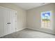 Cozy bedroom with neutral carpet, a window with natural light, and a double door closet at 1286 W Blackman Rd, Dunn, NC 28334