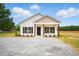 Charming single-story home featuring white siding, brown accents, and a well-manicured gravel driveway at 1286 W Blackman Rd, Dunn, NC 28334