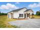 A charming single-story house boasts white siding, a dark roof, and a welcoming covered porch at 1286 W Blackman Rd, Dunn, NC 28334