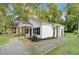 One-story home with black shutters, fresh landscaping, gravel driveway, and a welcoming front porch at 1286 W Blackman Rd, Dunn, NC 28334