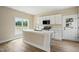 Bright kitchen features white cabinets, modern appliances, and center island with stone countertop and stainless faucet at 1286 W Blackman Rd, Dunn, NC 28334