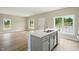 Open floor plan with kitchen island featuring stone countertop, double sink, and stainless faucet at 1286 W Blackman Rd, Dunn, NC 28334