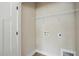 Simple laundry room with white door, white walls, and connection for laundry appliances at 1286 W Blackman Rd, Dunn, NC 28334