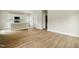Bright living space with light wood floors opening to a modern kitchen and multiple doorways at 1286 W Blackman Rd, Dunn, NC 28334