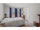 Cozy bedroom with a large window dressed with blue curtains, offering ample natural light at 129 Shawnee Dr, Louisburg, NC 27549