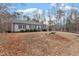 Quaint home with a long driveway and a view of the surrounding wooded area at 129 Shawnee Dr, Louisburg, NC 27549