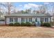 Charming single-story home featuring a well-maintained lawn, tidy bushes, and a welcoming entryway at 129 Shawnee Dr, Louisburg, NC 27549