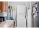 An eye-level view of laundry area equipped with a stacked washer and dryer, detergent, and cleaning supplies at 129 Shawnee Dr, Louisburg, NC 27549