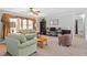 Comfortable living room featuring large windows, plush seating, and decorative shelving at 129 Shawnee Dr, Louisburg, NC 27549
