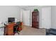 Inviting study area with a dark wood desk, chair, and a large bookcase for storage at 129 Shawnee Dr, Louisburg, NC 27549