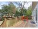 Outdoor deck with wooden railings and a seating area, surrounded by a lush green backyard at 1304 N Duke St, Durham, NC 27701