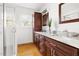 Bright bathroom with double vanity, granite countertop, and glass shower at 1304 N Duke St, Durham, NC 27701