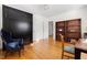 Bright bedroom with hardwood floors, writing desk, and dark wood bookcase at 1304 N Duke St, Durham, NC 27701