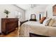 Bedroom with hardwood floors, white walls, dark wood furniture at 1304 N Duke St, Durham, NC 27701