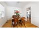 A dining room featuring wainscoting, hardwood floors, and views into an updated kitchen at 1304 N Duke St, Durham, NC 27701