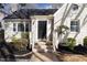 Charming home featuring classic brickwork, complemented by well-manicured shrubs and brick steps at 1304 N Duke St, Durham, NC 27701