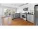 This light and bright kitchen features stainless appliances and access to a back deck at 1304 N Duke St, Durham, NC 27701