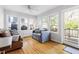 This sunroom features hardwood floors, ample natural light, and comfortable seating at 1304 N Duke St, Durham, NC 27701