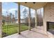 Back porch featuring an outdoor fireplace, ceiling fan, and views of the lake, great for relaxing outdoors at 164 Arabella Ct, Cary, NC 27518