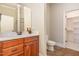 Bathroom featuring wood vanity, marble countertops, and tile floor, blending functionality and style at 164 Arabella Ct, Cary, NC 27518