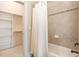 Bathroom featuring a shower with tile and a closet for linen storage, blending comfort and style at 164 Arabella Ct, Cary, NC 27518