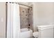 Bathroom with decorative tiled shower over tub and a white shower curtain at 164 Arabella Ct, Cary, NC 27518