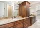 Double vanity bathroom with granite counters, wood cabinets, and vessel sinks at 164 Arabella Ct, Cary, NC 27518