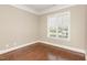 Bedroom with hardwood floors, crown moulding, and a large window at 164 Arabella Ct, Cary, NC 27518
