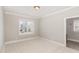Neutral bedroom featuring wall to wall carpeting and window with plantation shutters at 164 Arabella Ct, Cary, NC 27518