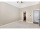 Neutral bedroom featuring bright carpet, tray ceiling and access to the ensuite bathroom at 164 Arabella Ct, Cary, NC 27518