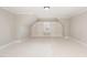 Upstairs bonus room with a built-in display niche with shelves and carpeted floors at 164 Arabella Ct, Cary, NC 27518