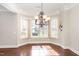 Elegant dining area with hardwood floors, large windows, and decorative lighting, showcasing a bright and open space at 164 Arabella Ct, Cary, NC 27518