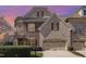 Beautiful two-story home with brick and stone facade, an attached two-car garage, and a manicured front yard at 164 Arabella Ct, Cary, NC 27518