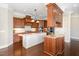 Gourmet kitchen featuring custom wood cabinets, granite countertops, a center island, and stainless steel appliances at 164 Arabella Ct, Cary, NC 27518