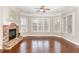 Bright living room featuring a stone fireplace, hardwood floors, and windows that provide natural light at 164 Arabella Ct, Cary, NC 27518