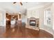 Spacious living room with hardwood floors, a stone fireplace, and an open layout leading to the kitchen at 164 Arabella Ct, Cary, NC 27518