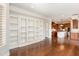 Open-concept living area with a built-in bookshelf, hardwood floors, and a view of the kitchen at 164 Arabella Ct, Cary, NC 27518
