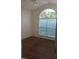 Inviting bedroom with arched window, hardwood floors, and soft natural light at 1906 Hawfields Crossing Ln, Mebane, NC 27302