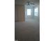 Spacious bedroom with carpeting, two windows providing natural light, and a door at 1906 Hawfields Crossing Ln, Mebane, NC 27302