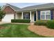 Charming single-story home with brick accents, manicured lawn, and inviting front porch at 1906 Hawfields Crossing Ln, Mebane, NC 27302